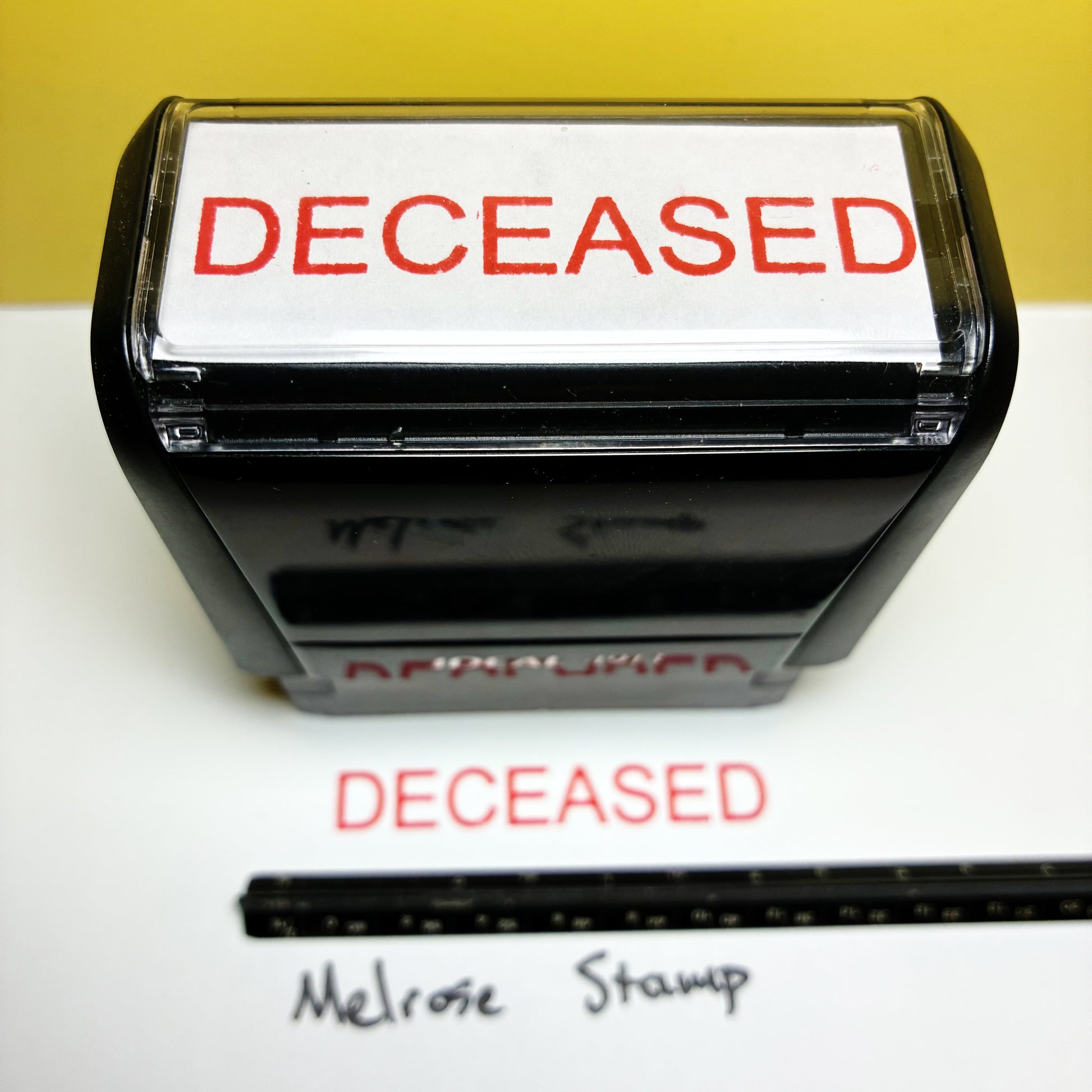 Stamp with 'DECEASED' text on a white background