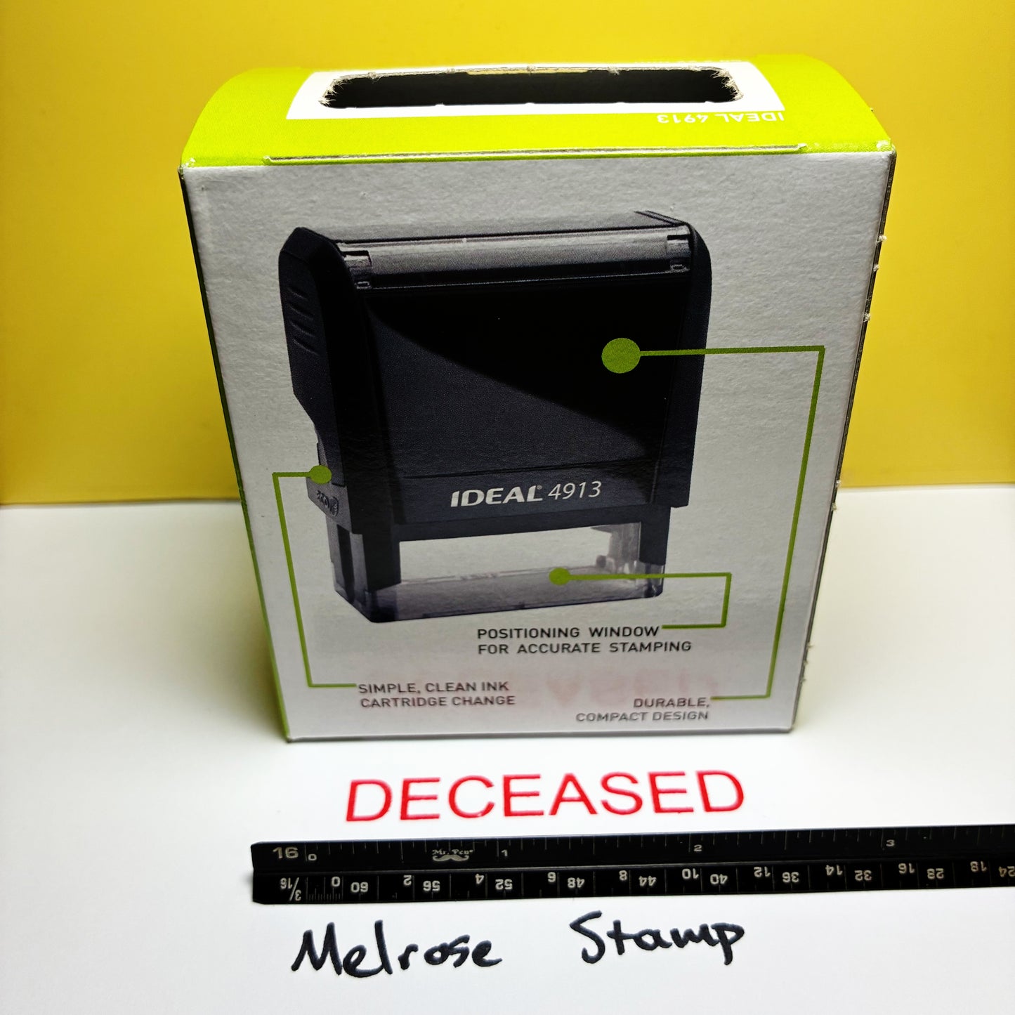Boxed stamp with 'DECEASED' text and ruler at the bottom on a yellow and white background