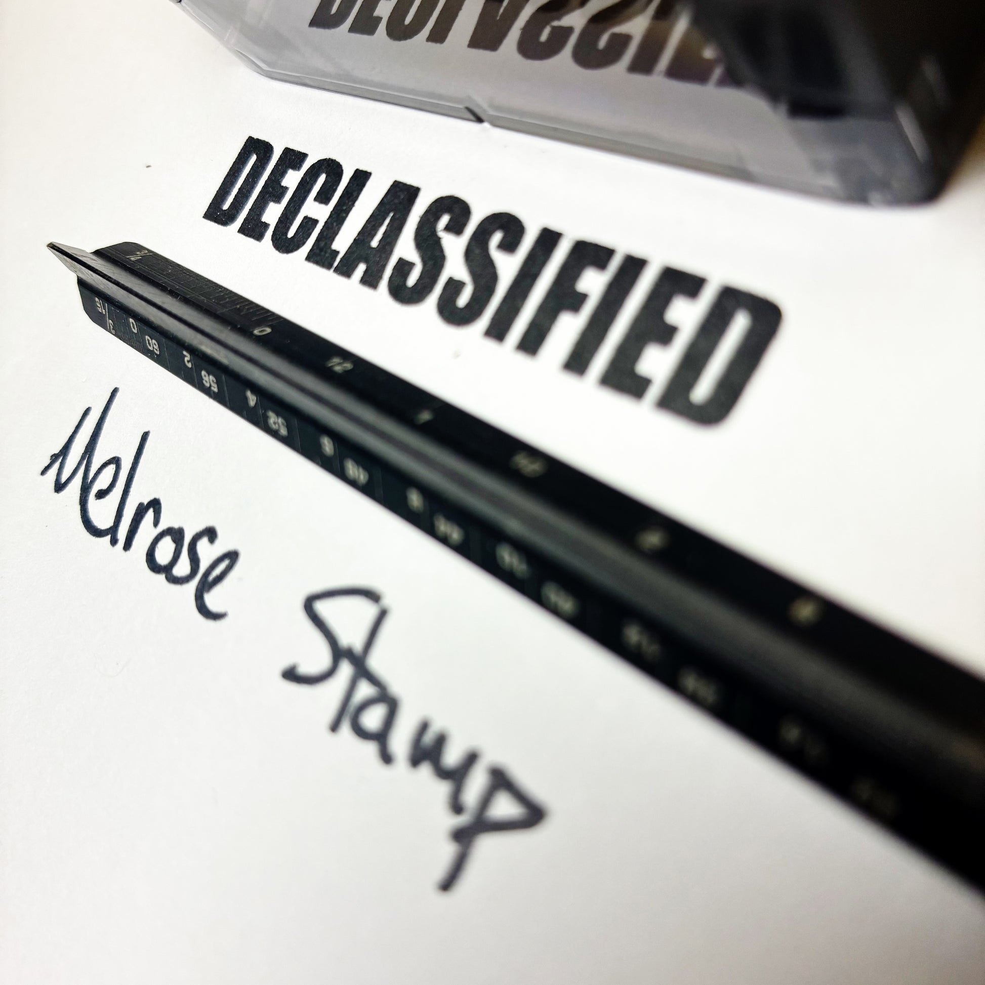 Rubber stamp with 'DECLASSIFIED' text on a white background