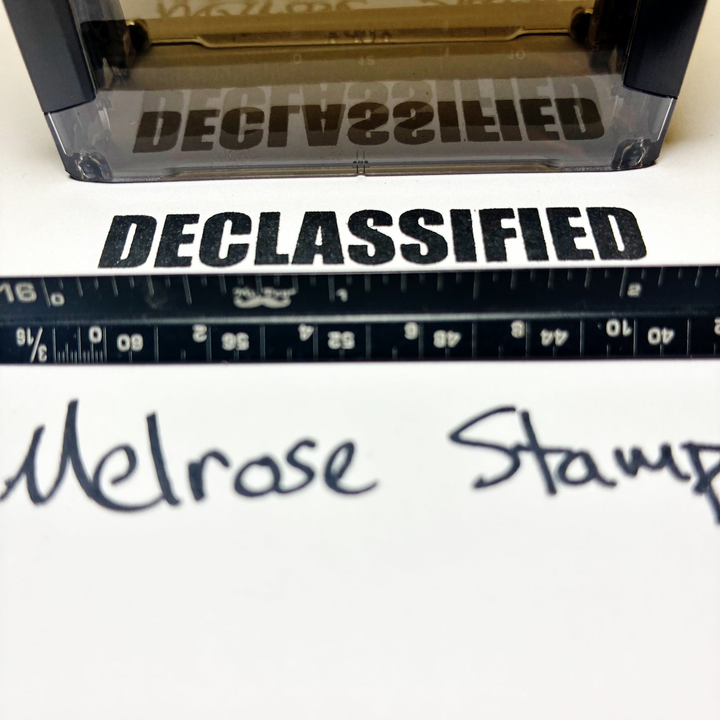 Declassified stamp with a ruler and 'Melrose Stamps' branding.