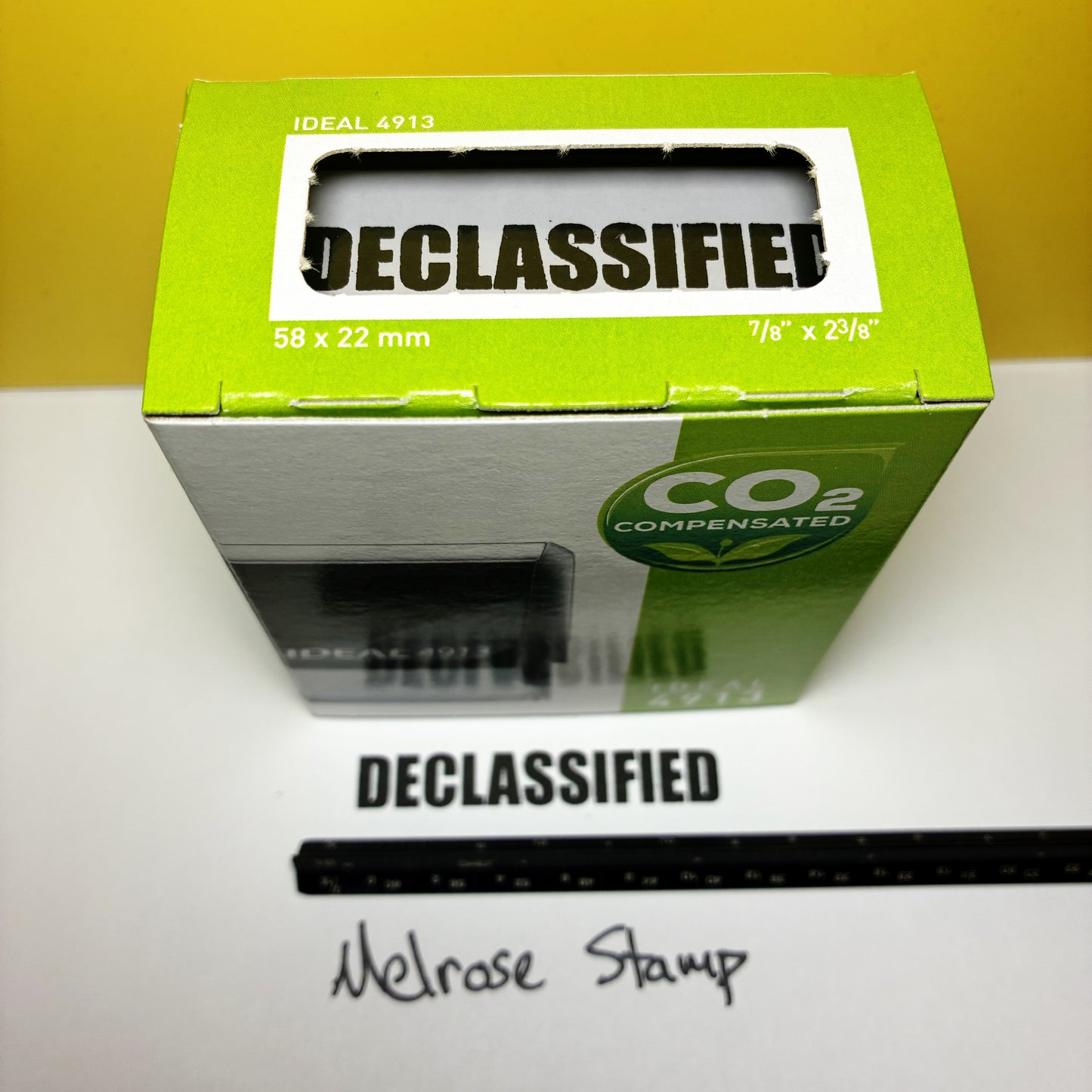 Green box labeled 'Declassified' with a white label on a white surface.