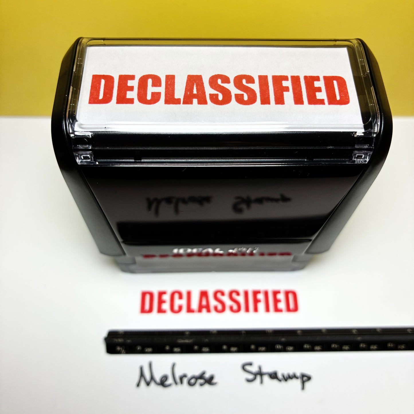 Declassified stamp with a piece of paper labeled 'DECLASSIFIED' on a white background.