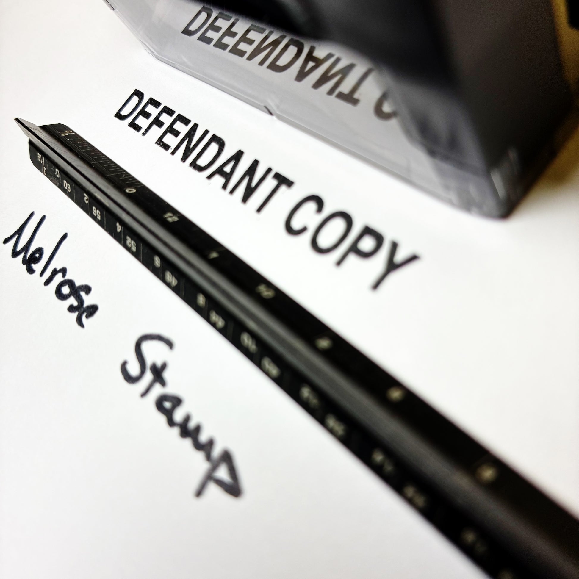 Rubber stamp with 'Defendant Copy' text on a white surface