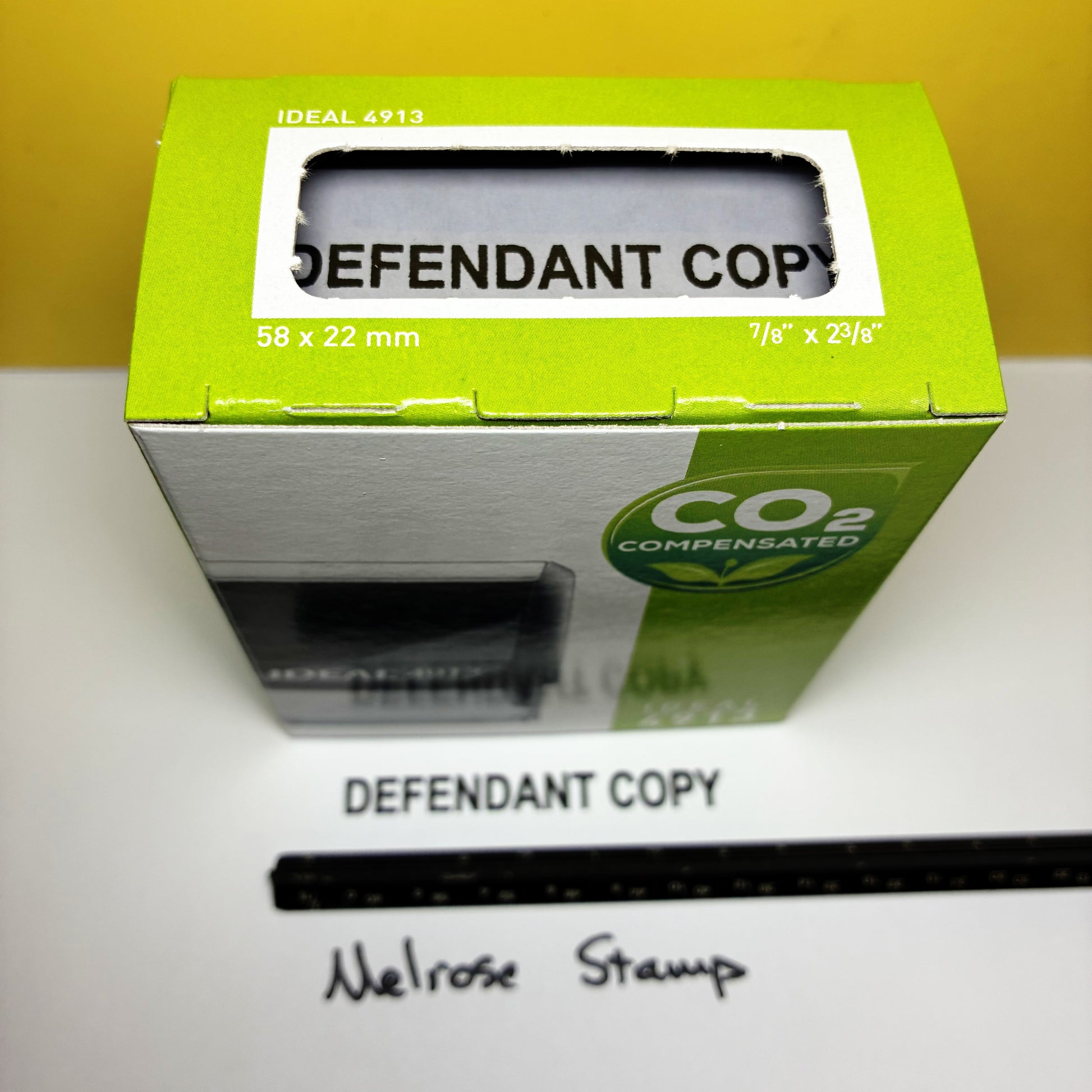 Green box labeled 'Defendant Copy' with  rubber stamp black ink on a yellow background