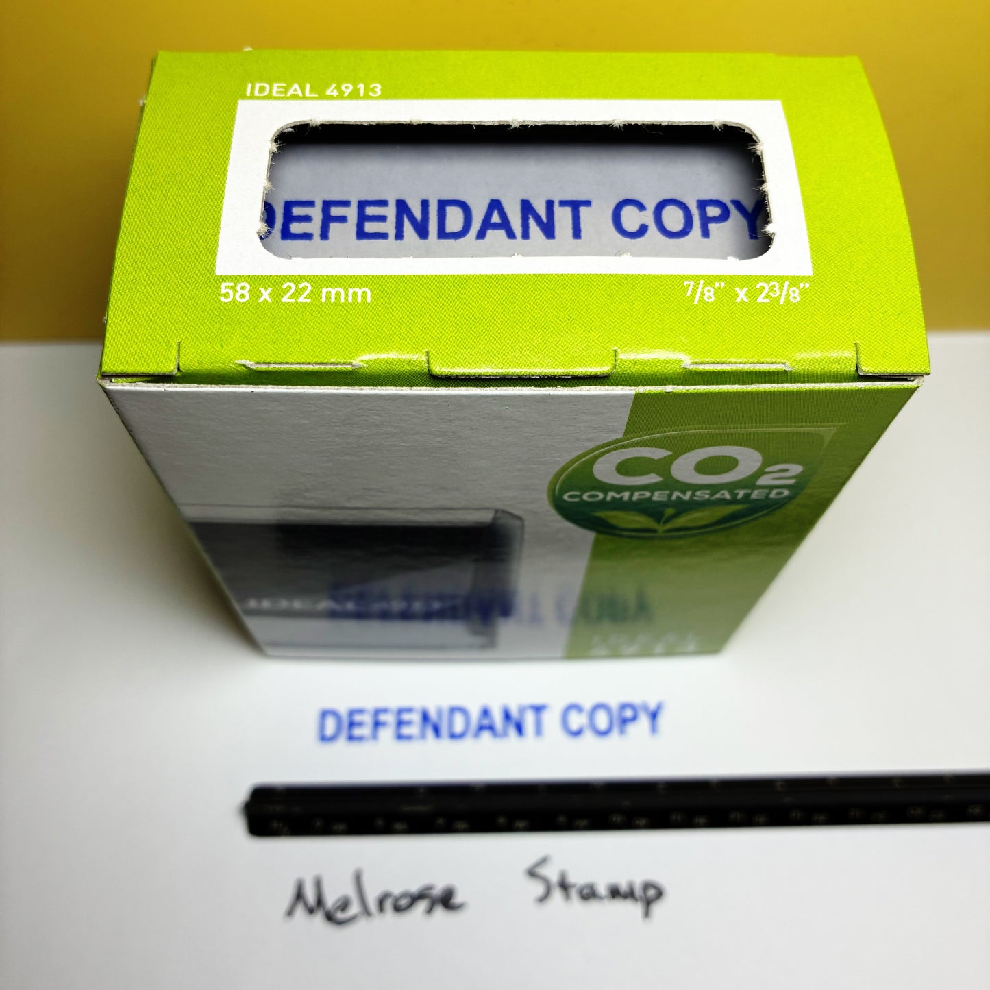 Green box with 'DEFENDANT COPY' text on a white surface