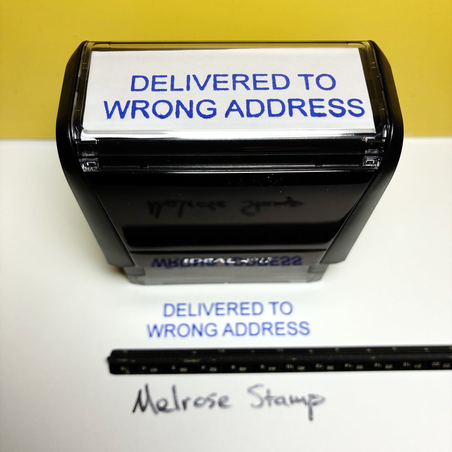 Self-inking stamp with 'Delivered to Wrong Address' text on a white background