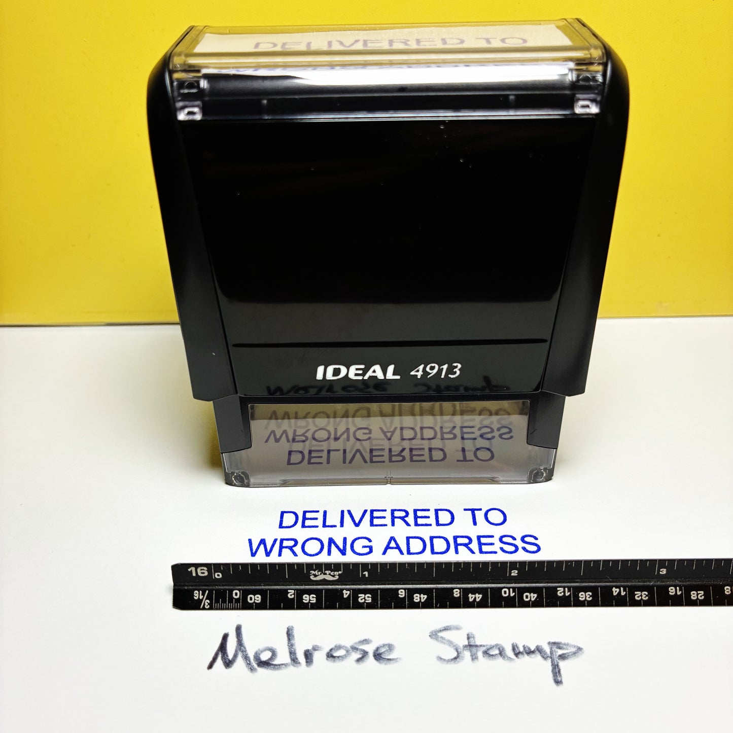 Rubber stamp with text 'Delivered to Wrong Address' on a yellow and white background