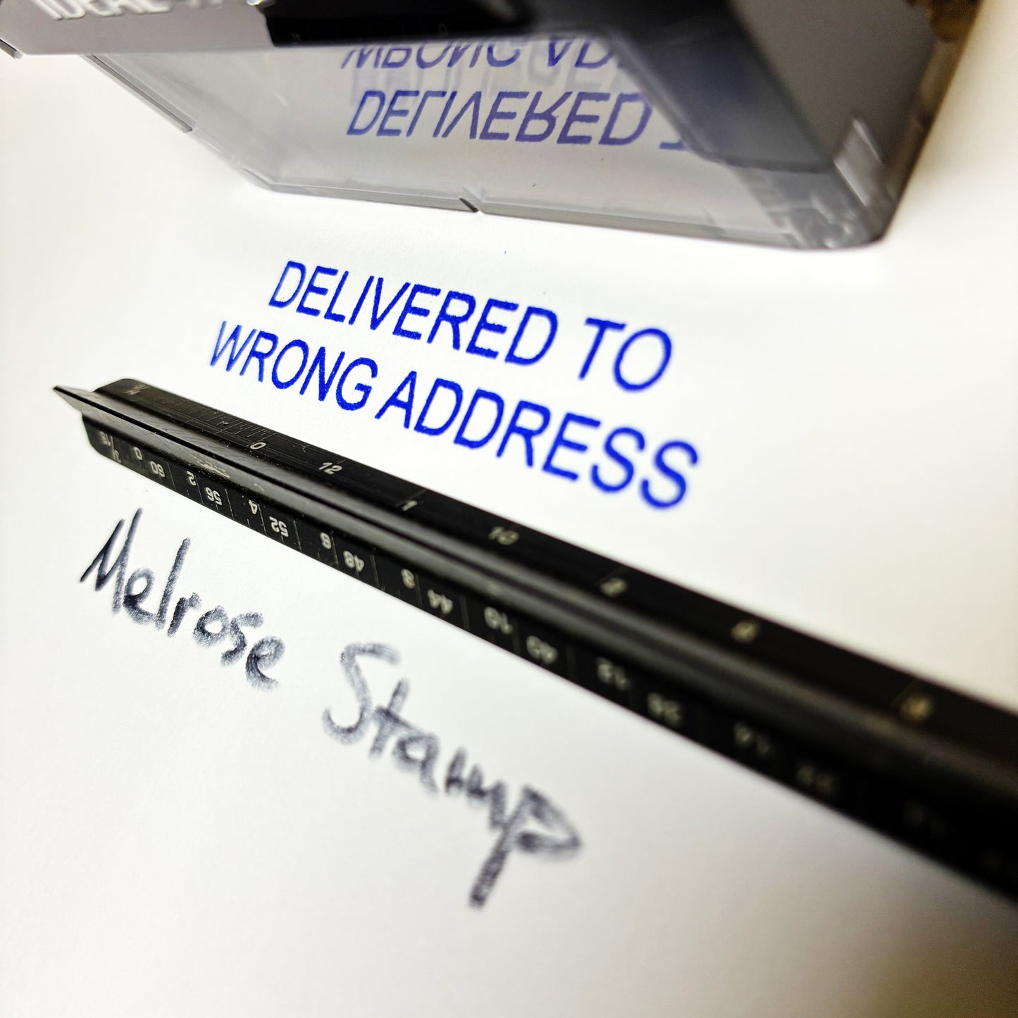 Rubber stamp with 'Delivered to Wrong Address' label and 'Melrose Stamp' handwritten text.