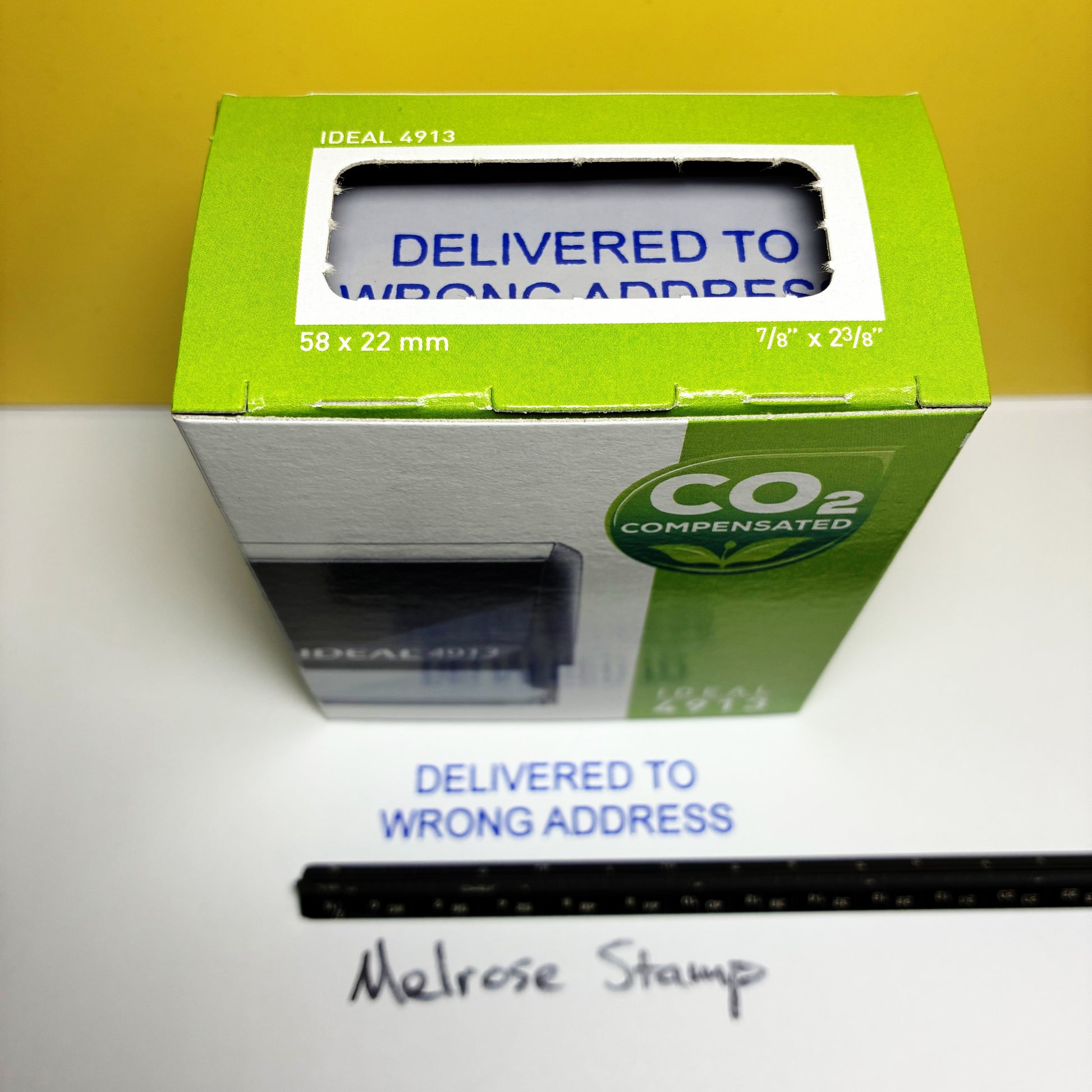 Green box with 'Delivered to Wrong Address' label on a white surface