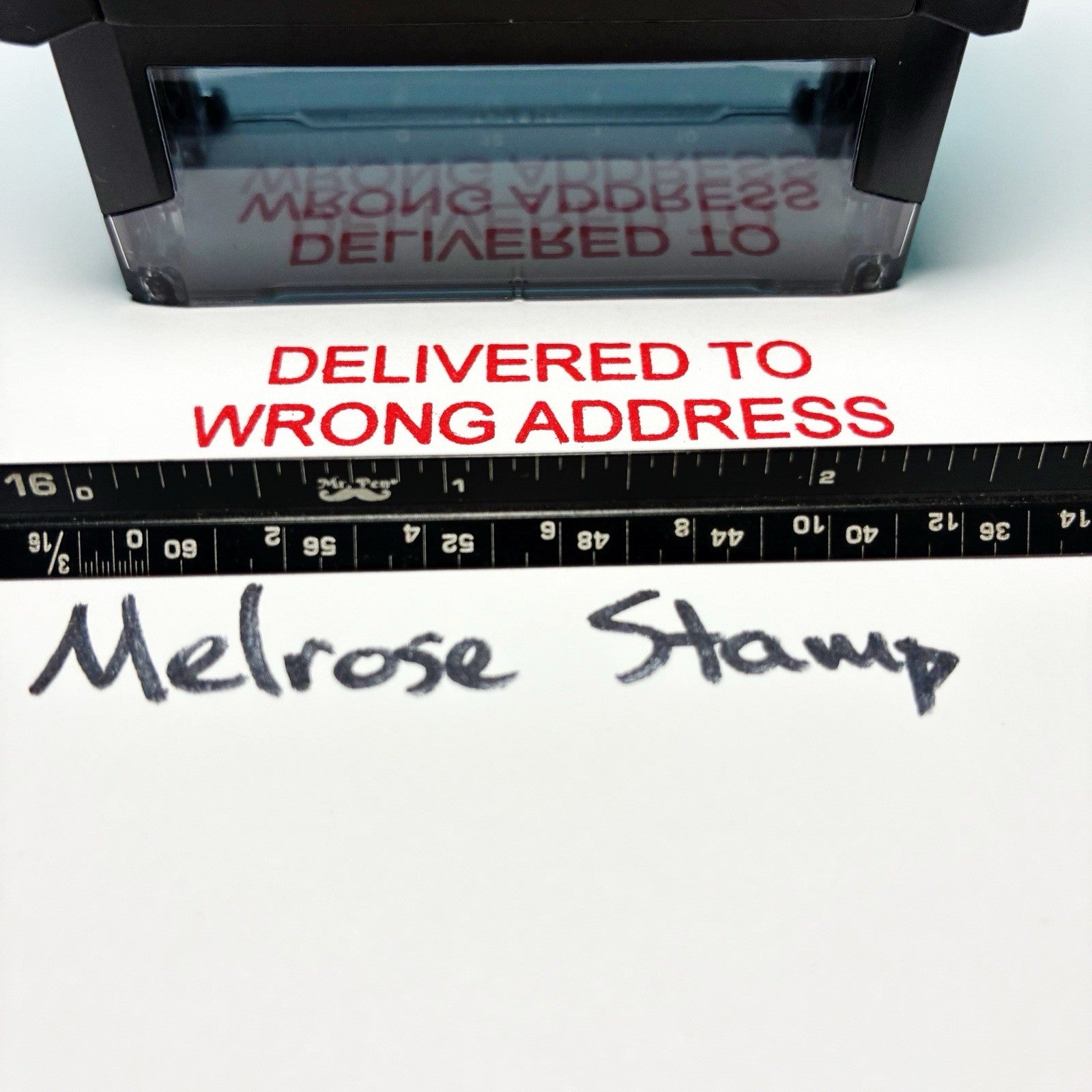 Rubber stamp with 'Delivered to Wrong Address' text on a white background