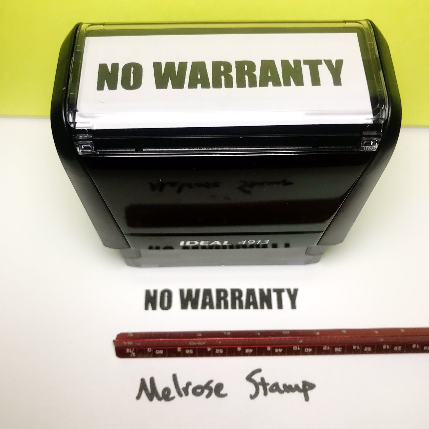 Rubber stamp with 'NO WARRANTY' text on a white background