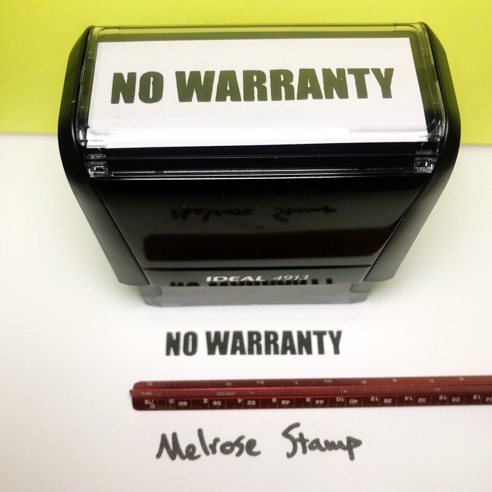 Rubber stamp with 'NO WARRANTY' text on a white background