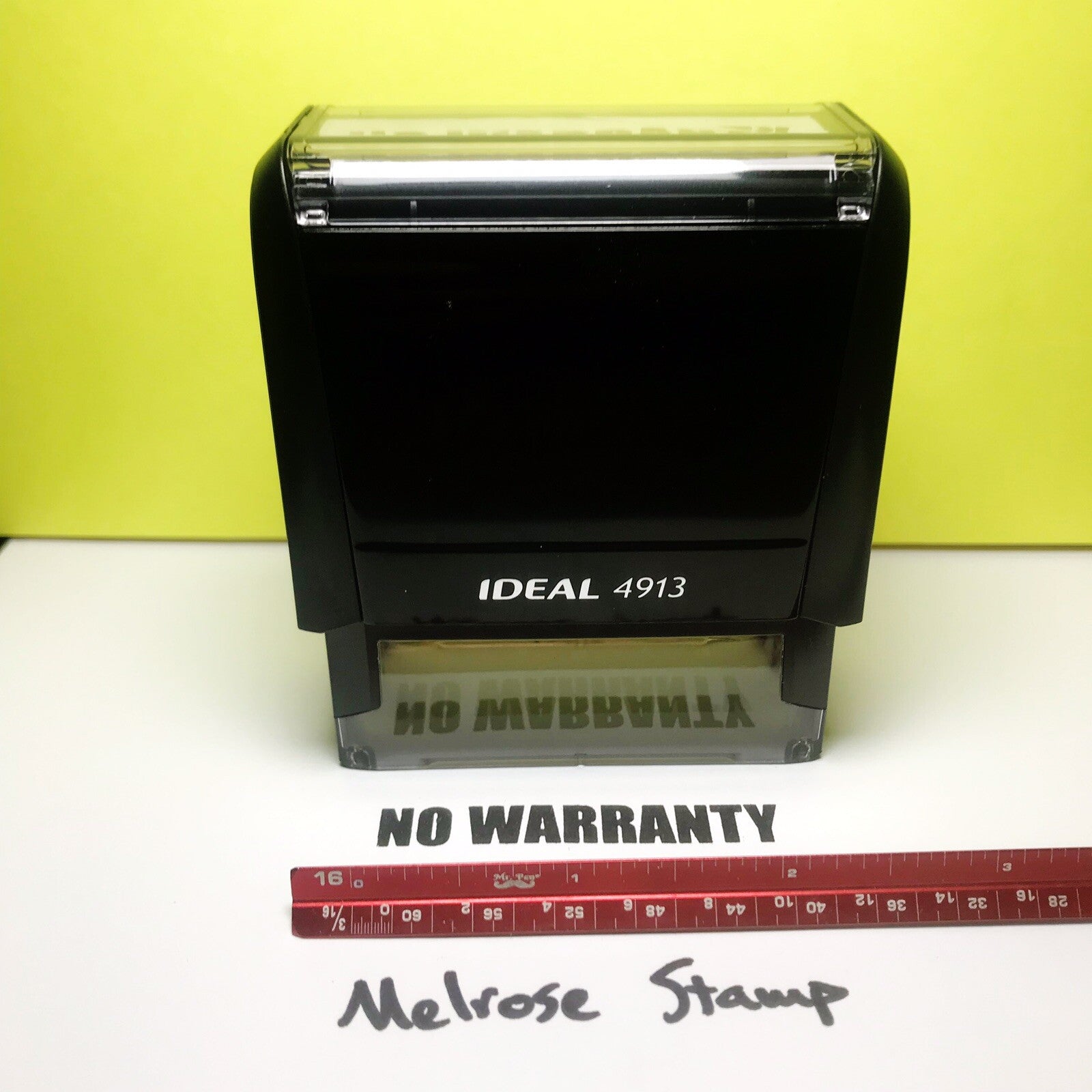 Black Ideal 4913 stamp with 'NO WARRANTY' text and a ruler for scale on a yellow background.