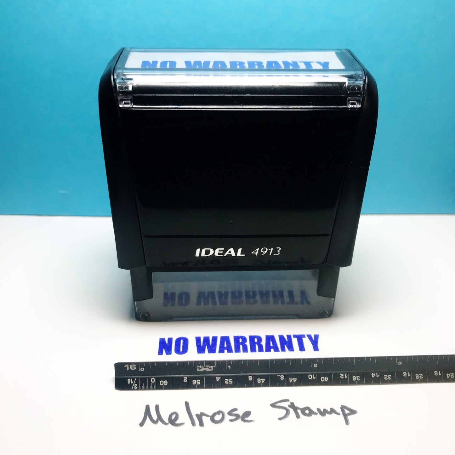 Rubber stamp with 'NO WARRANTY' text on a blue background