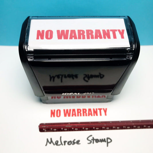 Rubber stamp with 'NO WARRANTY' text on a white surface with blue background