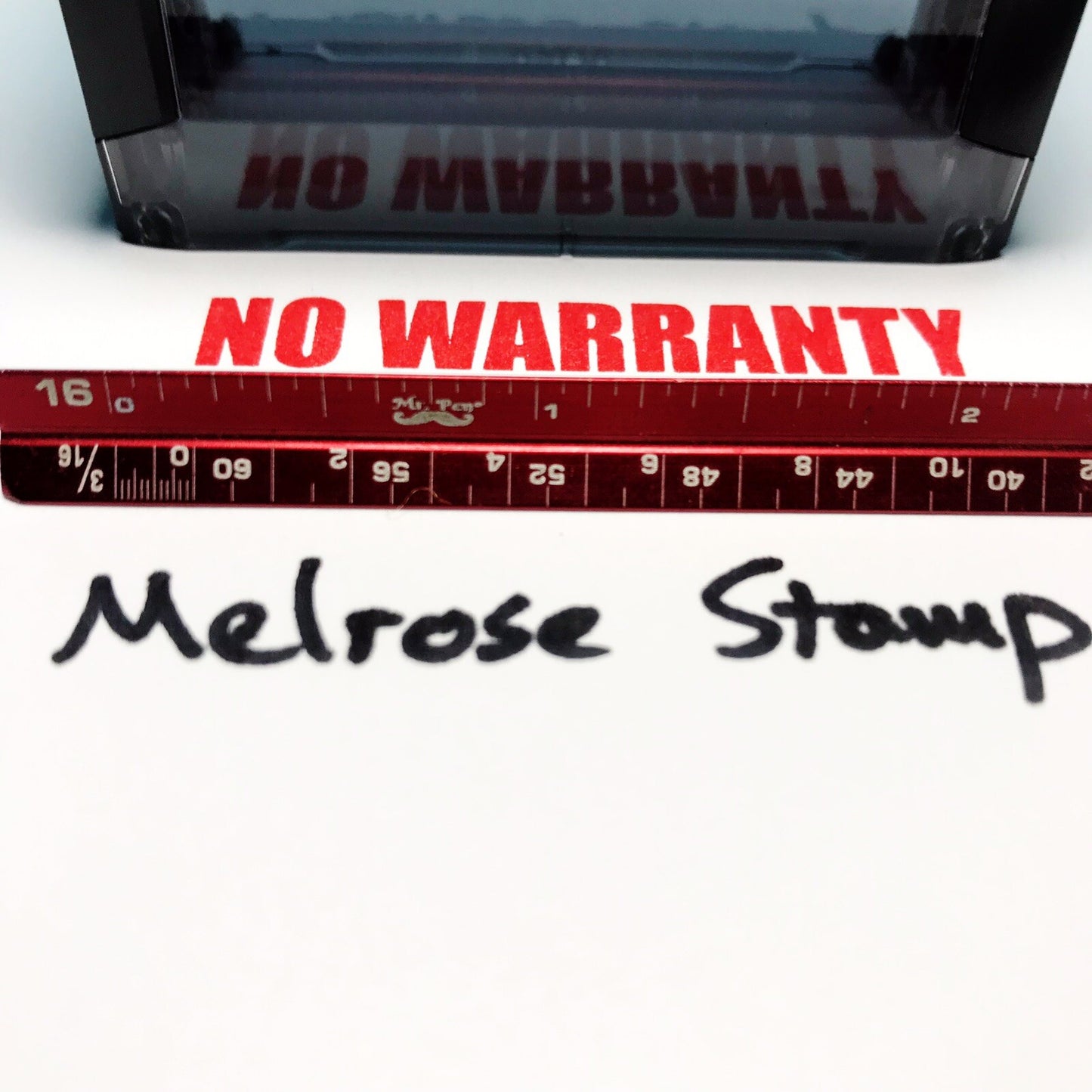 Red stamp with 'No Warranty' text and 'Melrose Stamp' branding on a white background.
