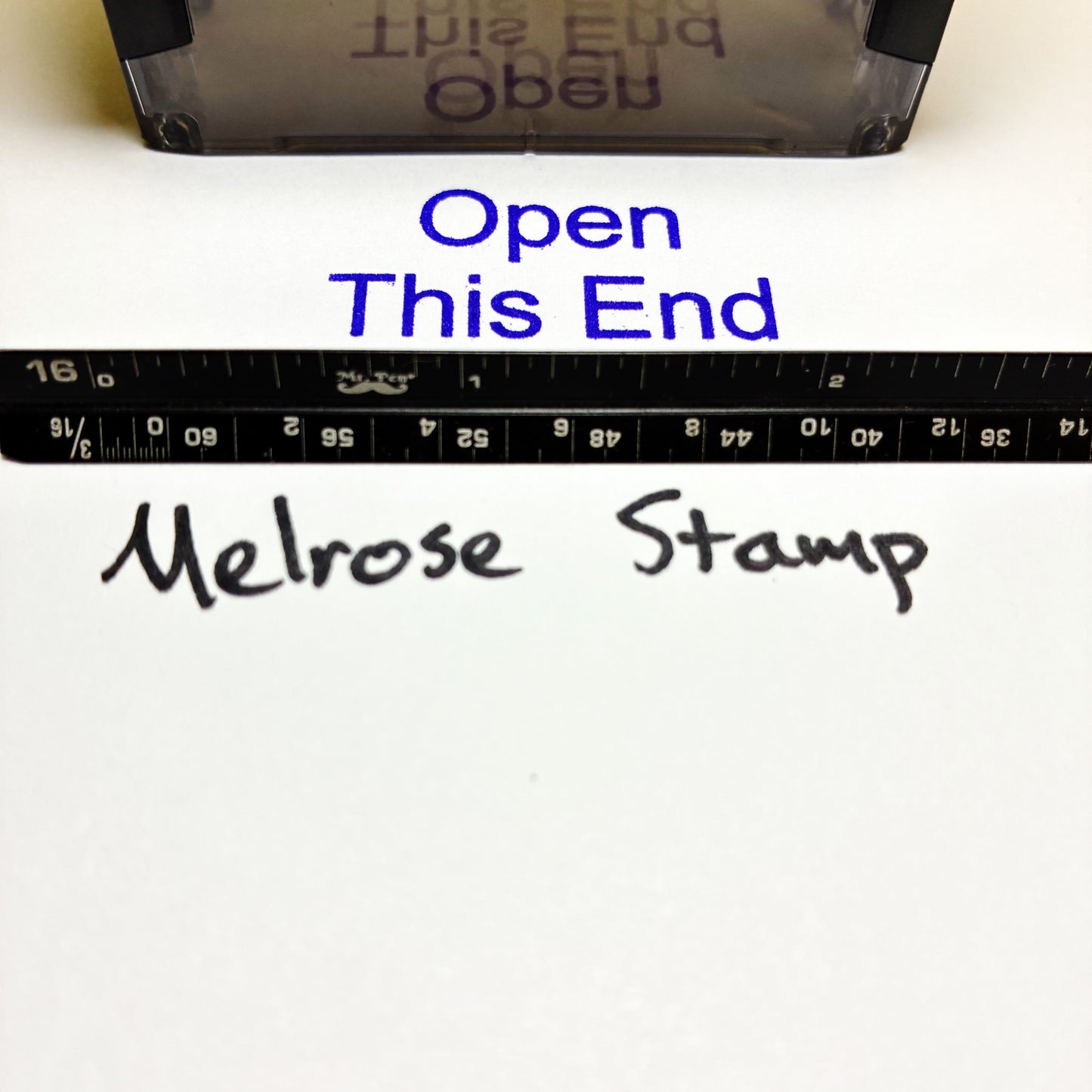 Melrose Stamp packaging with text 'Open This End' and a ruler for scale.