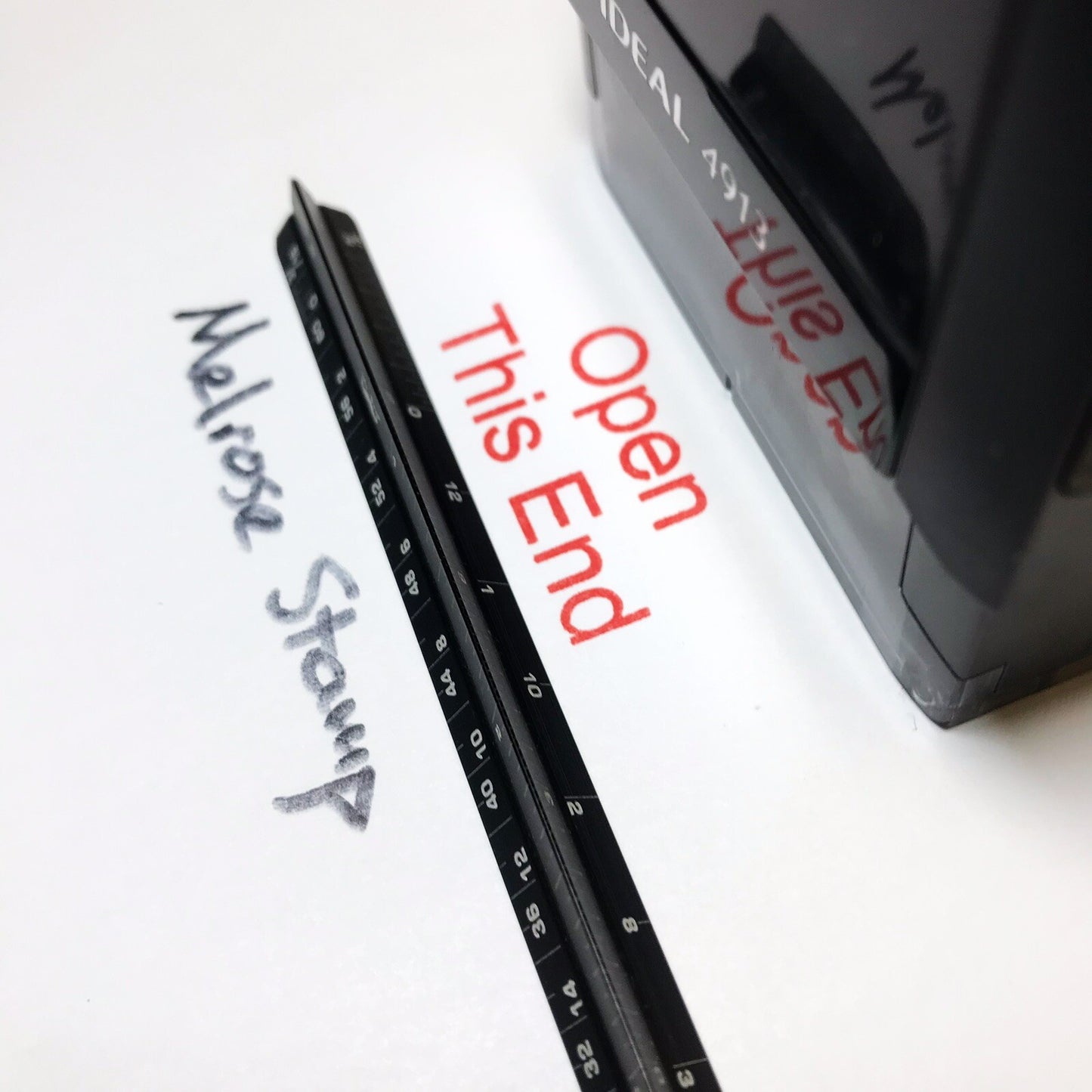 Open This End stamp impression on paper close up