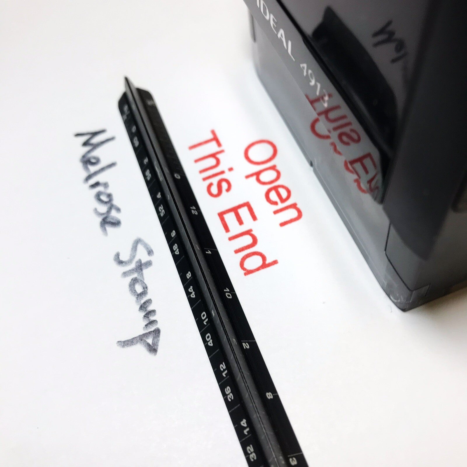 Open This End stamp impression on paper close up