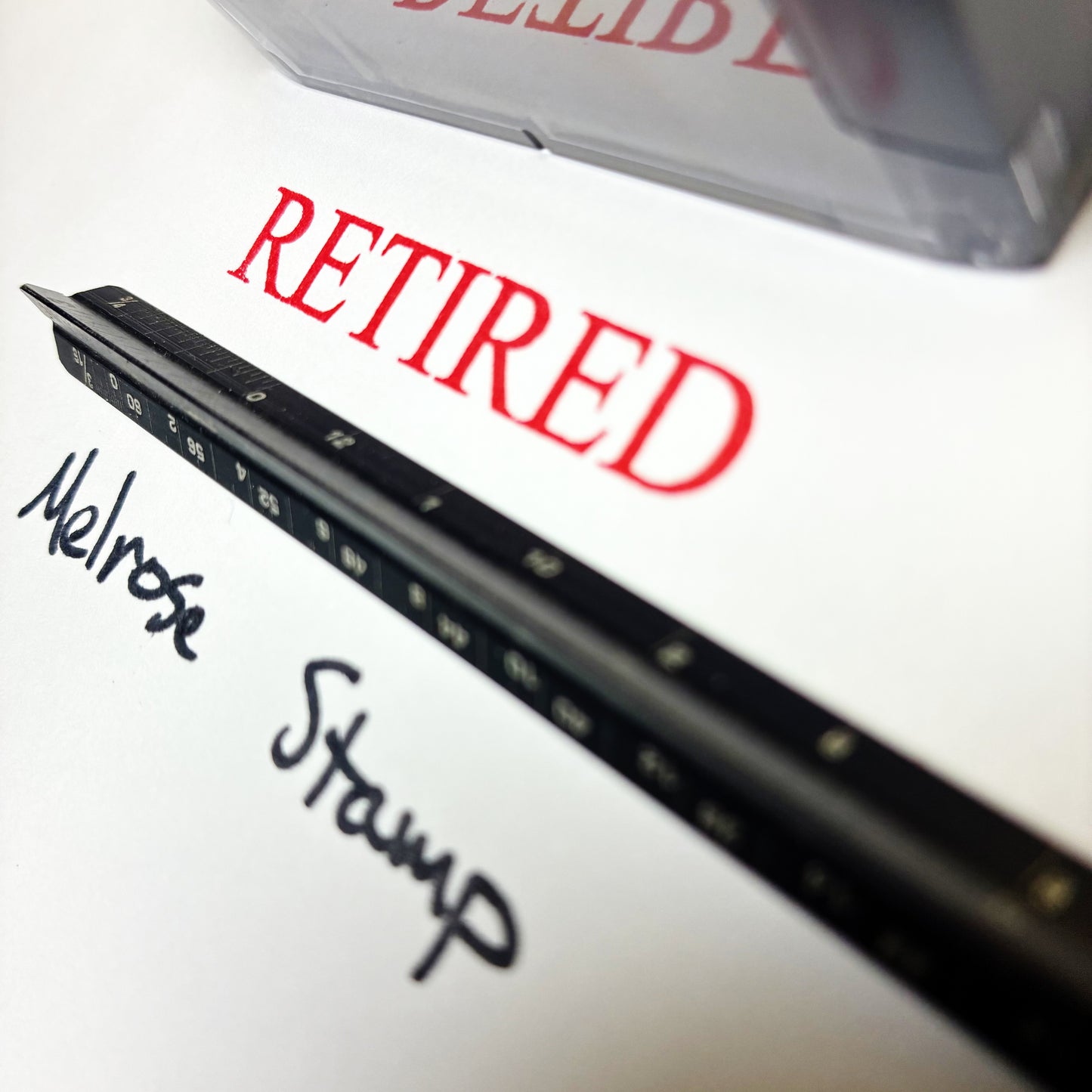 Black stamp with 'Retired' text on a white background, featuring a brand name.