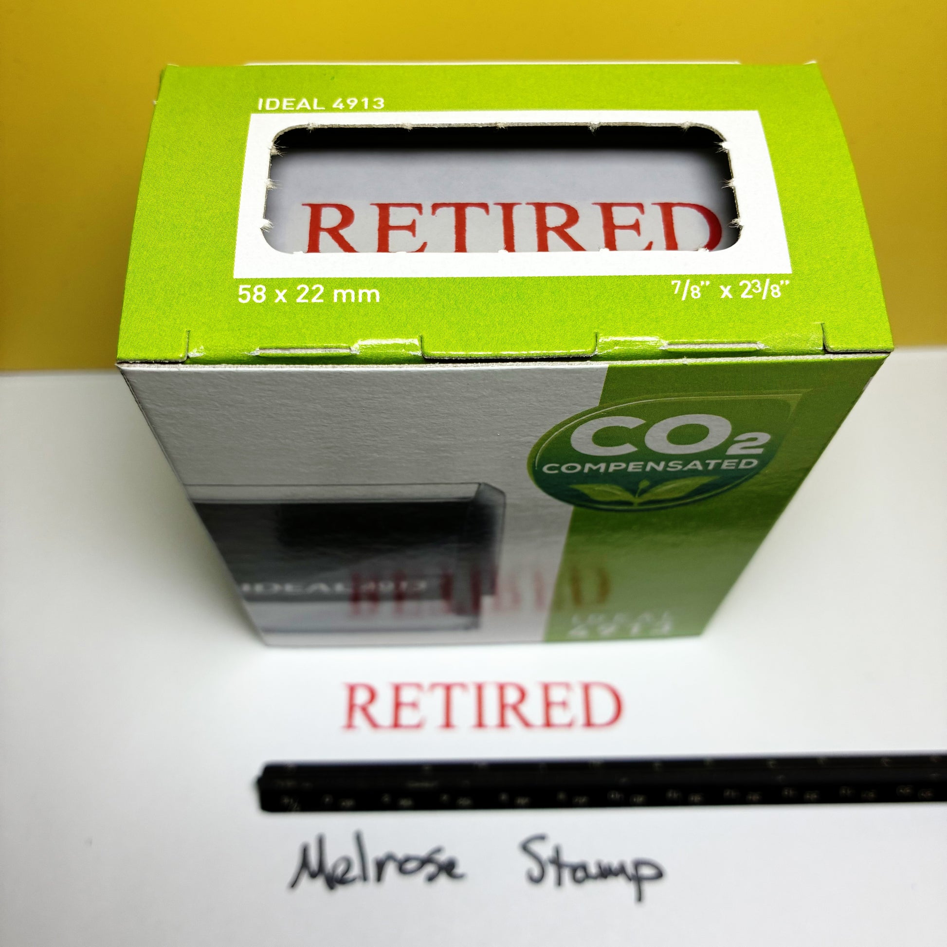 Stamp box with 'Retired' text on a white surface.