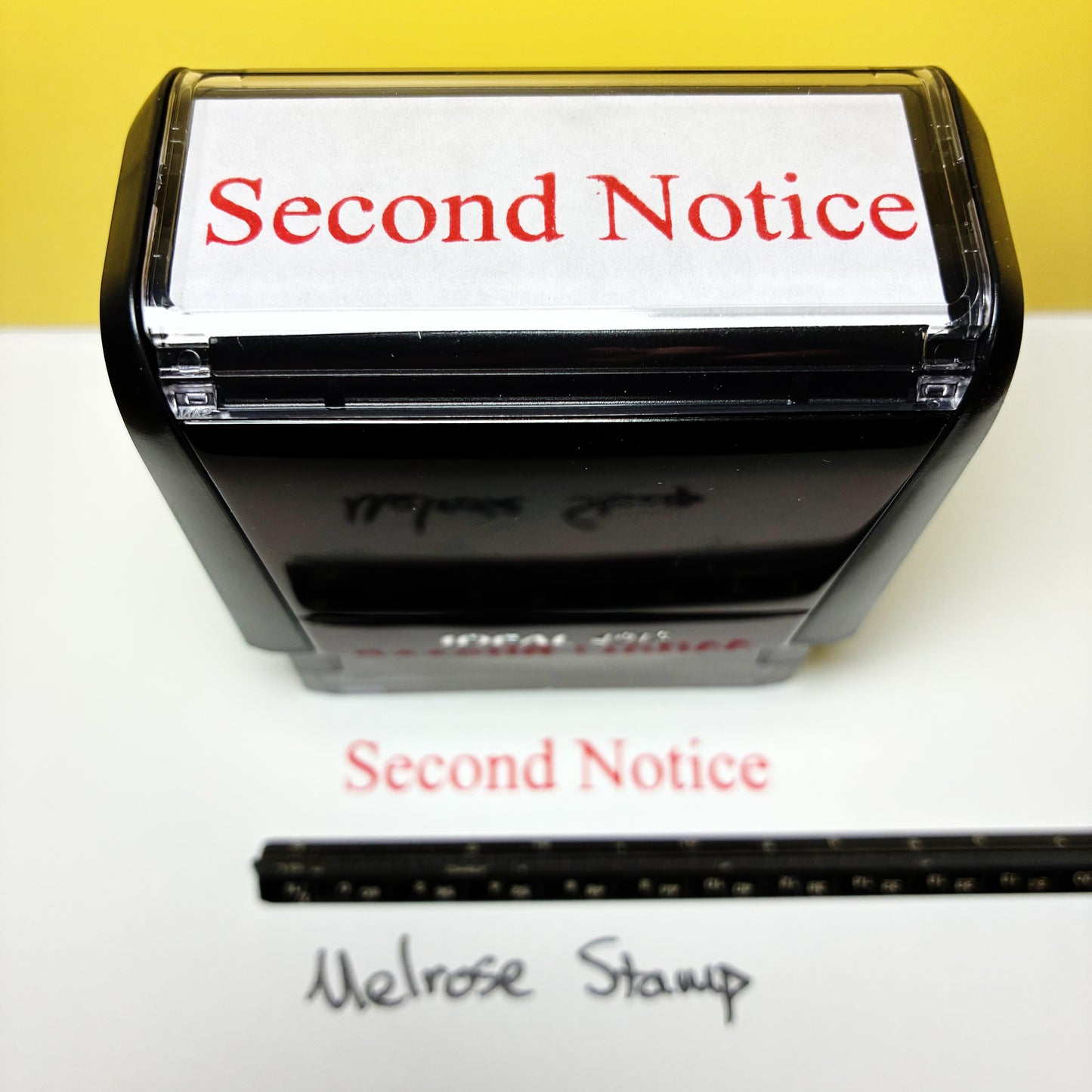 Rubber stamp with 'Second Notice' text on a white background