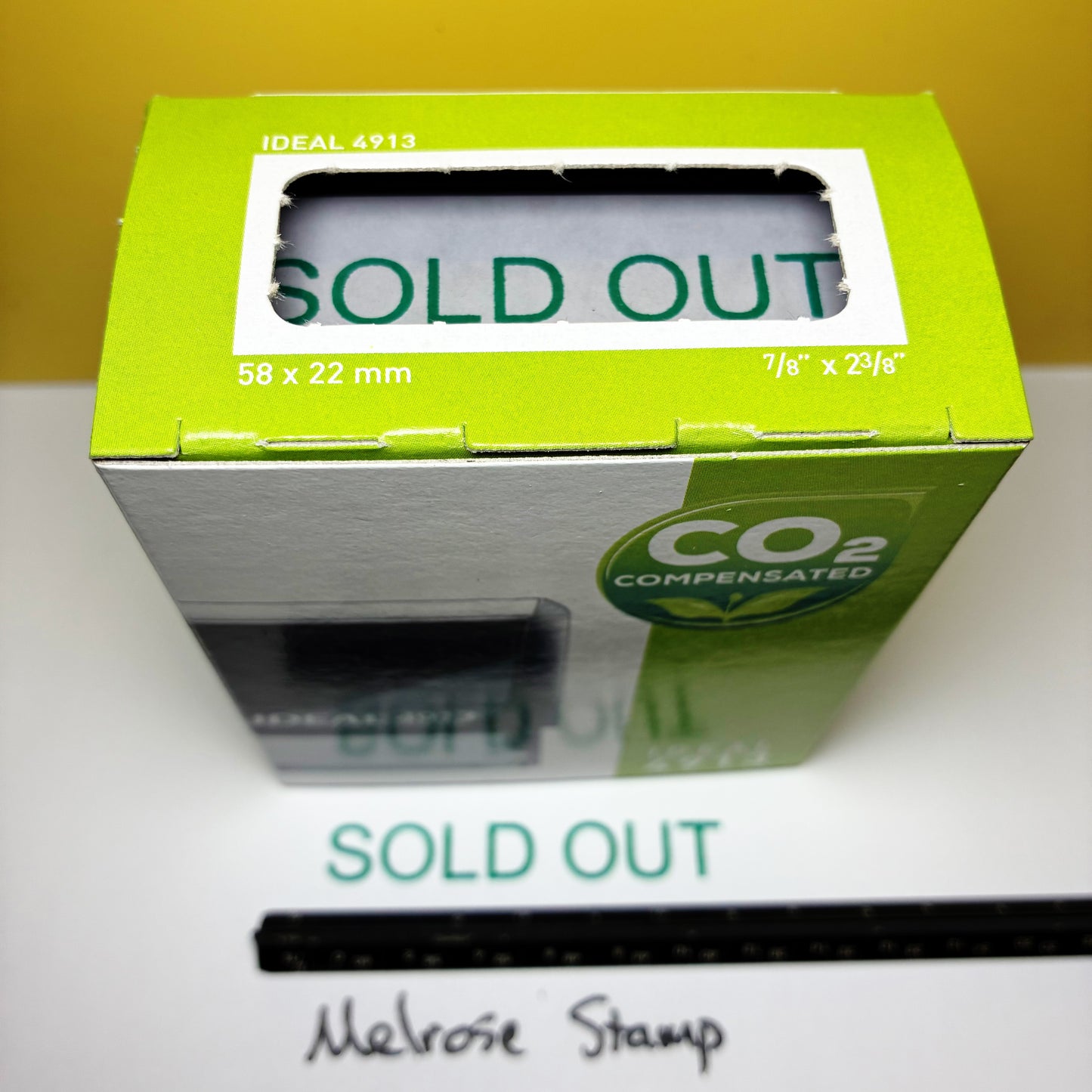 Green box with 'SOLD OUT' rubber stamp on a white surface
