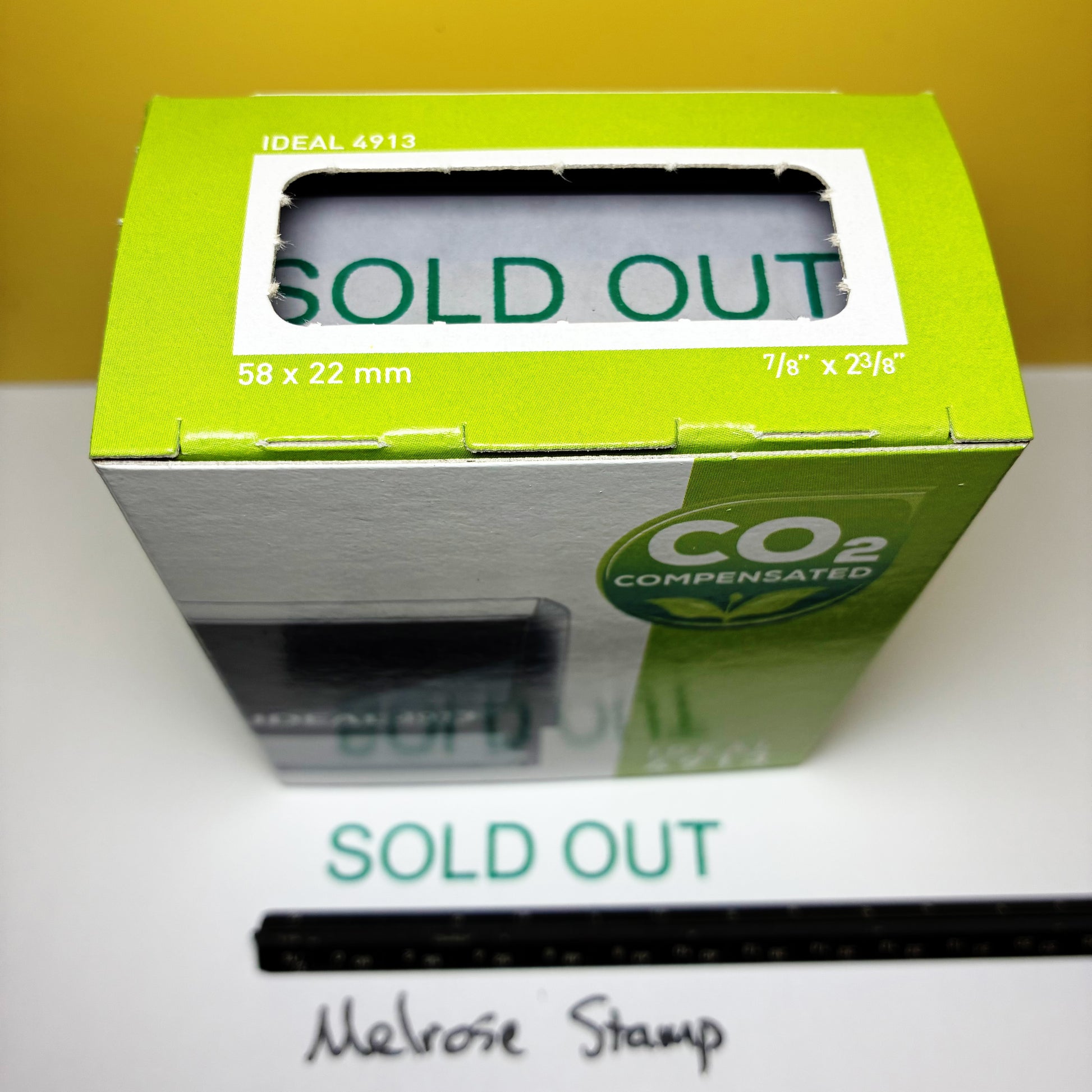 Green box with 'SOLD OUT' rubber stamp on a white surface