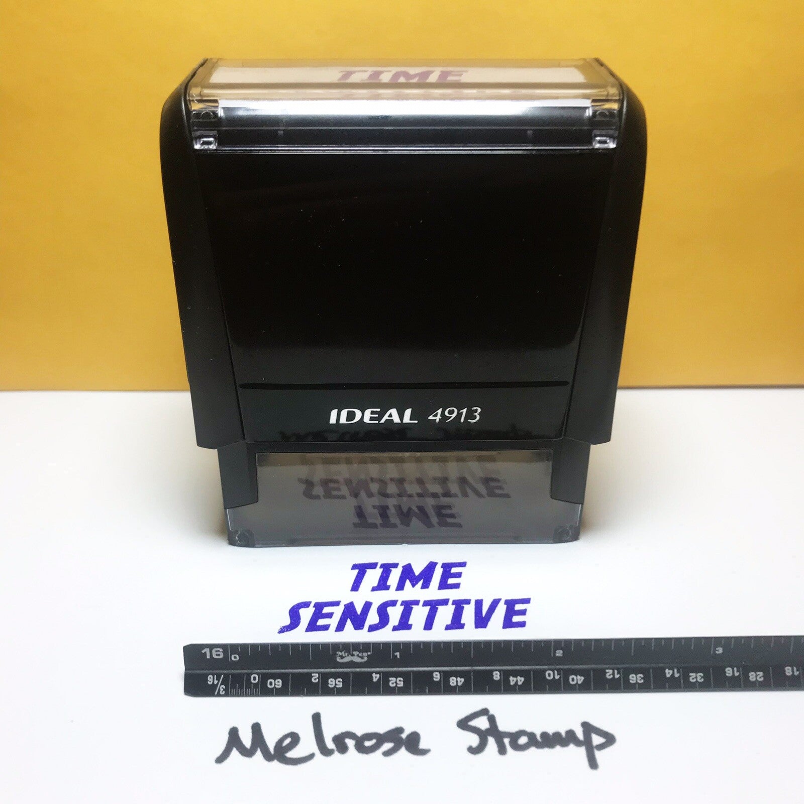 Rubber stamp Time Sensitive on a white surface with a yellow background