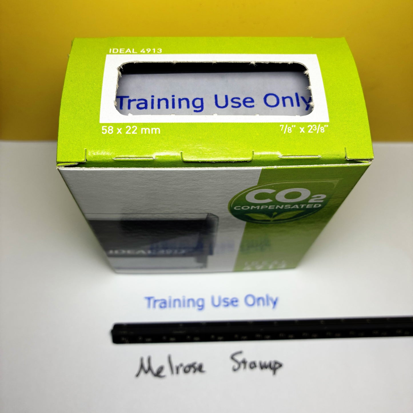 Stamper box with 'Training Use Only' label on a white surface