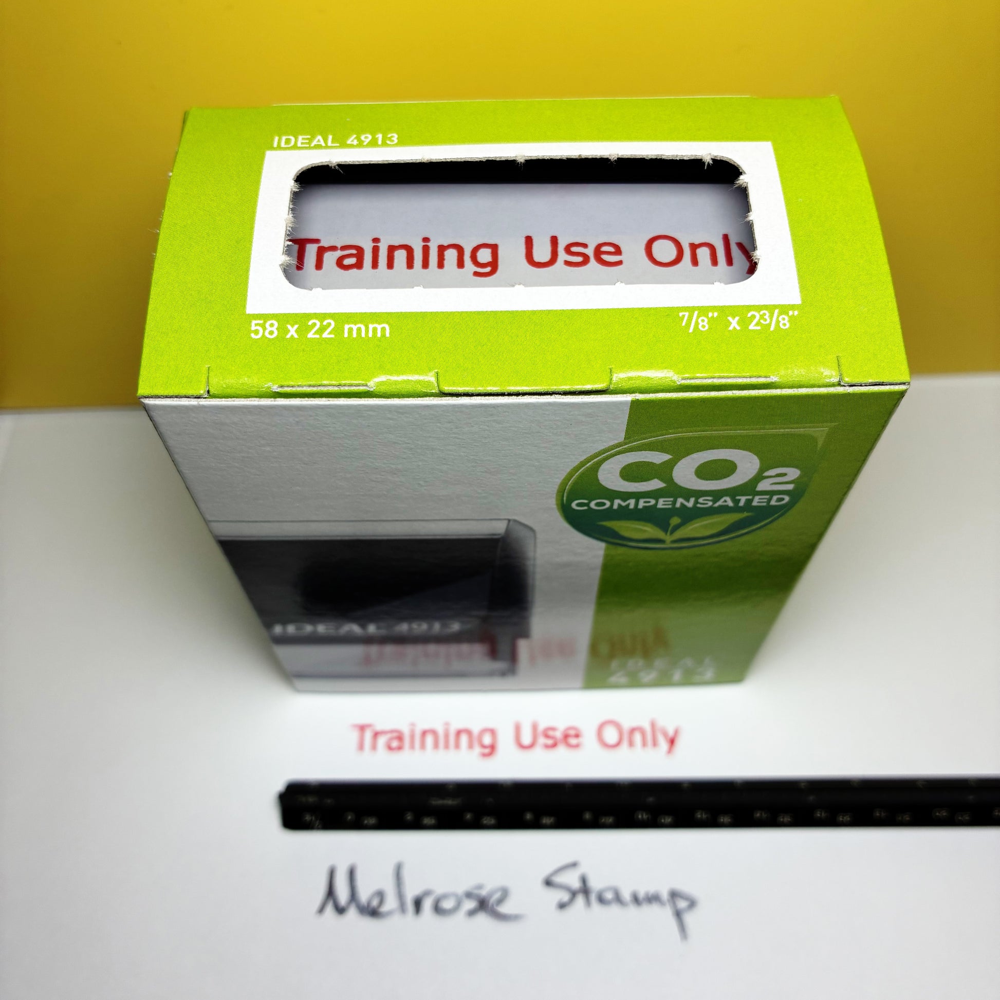 Rubber stamp in a green box with 'Training Use Only' label on a white surface.