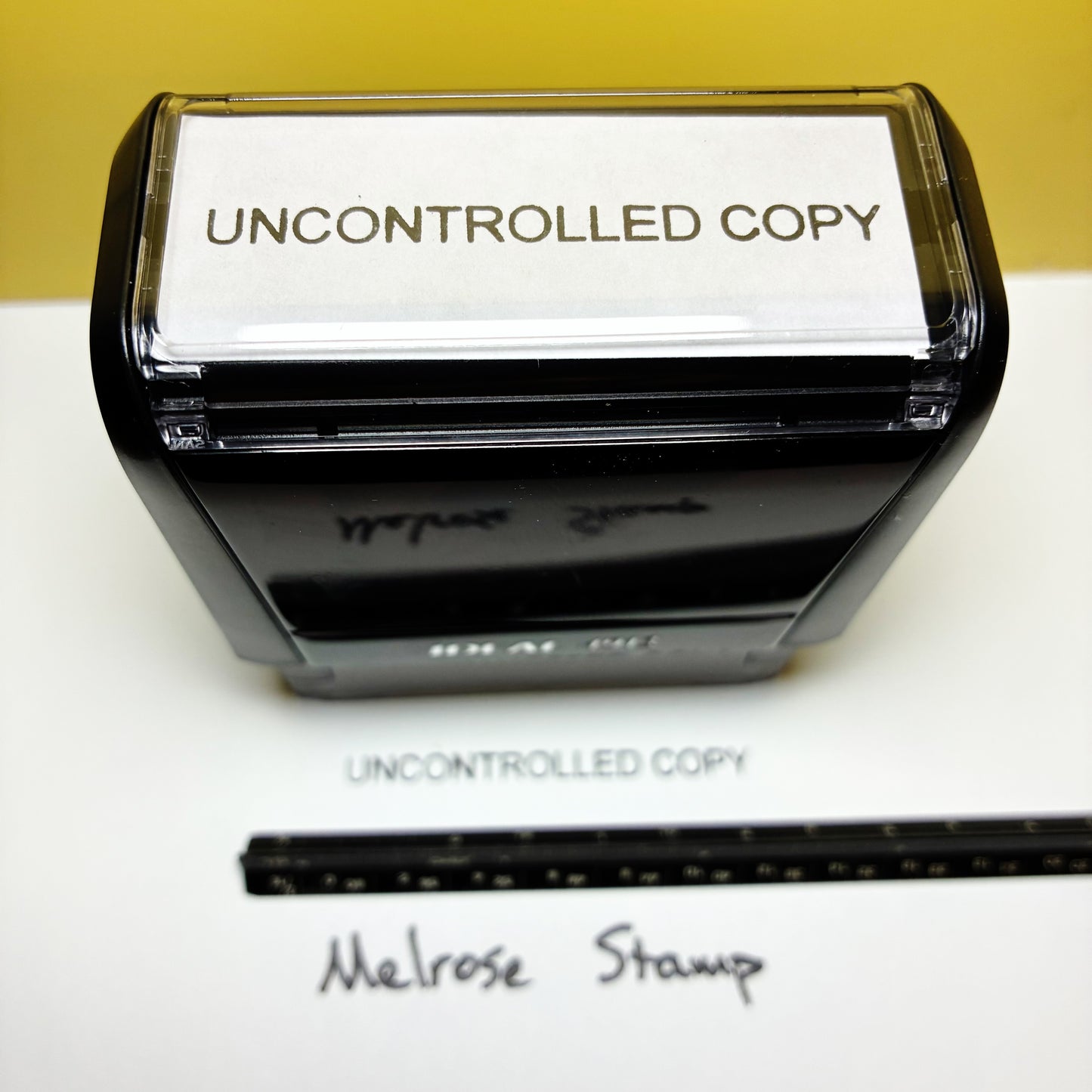 Rubber stamp with 'UNCONTROLLED COPY' text black ink on a white background