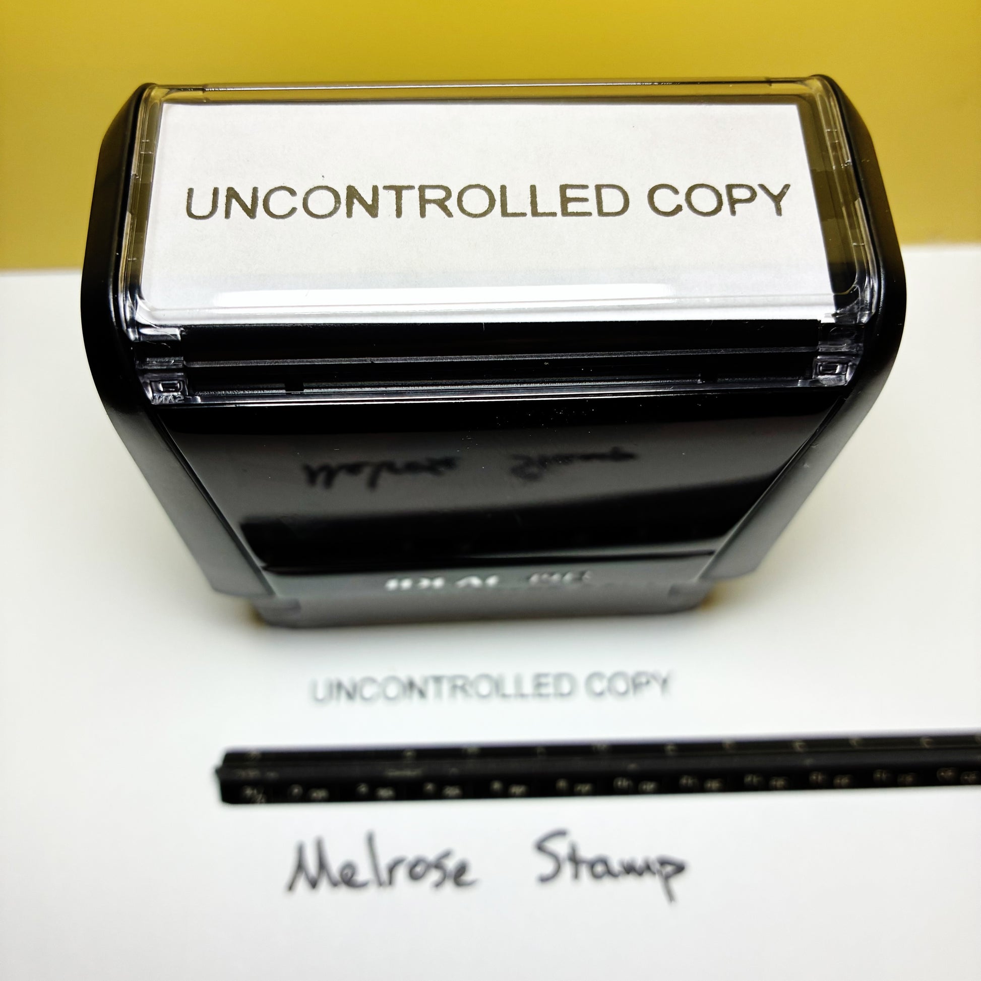 Rubber stamp with 'UNCONTROLLED COPY' text black ink on a white background
