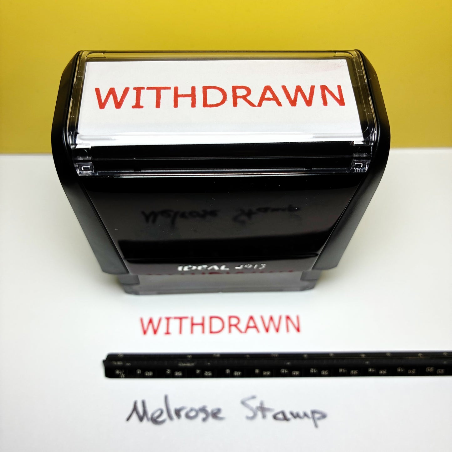 Rubber stamp with 'WITHDRAWN' text on a white background