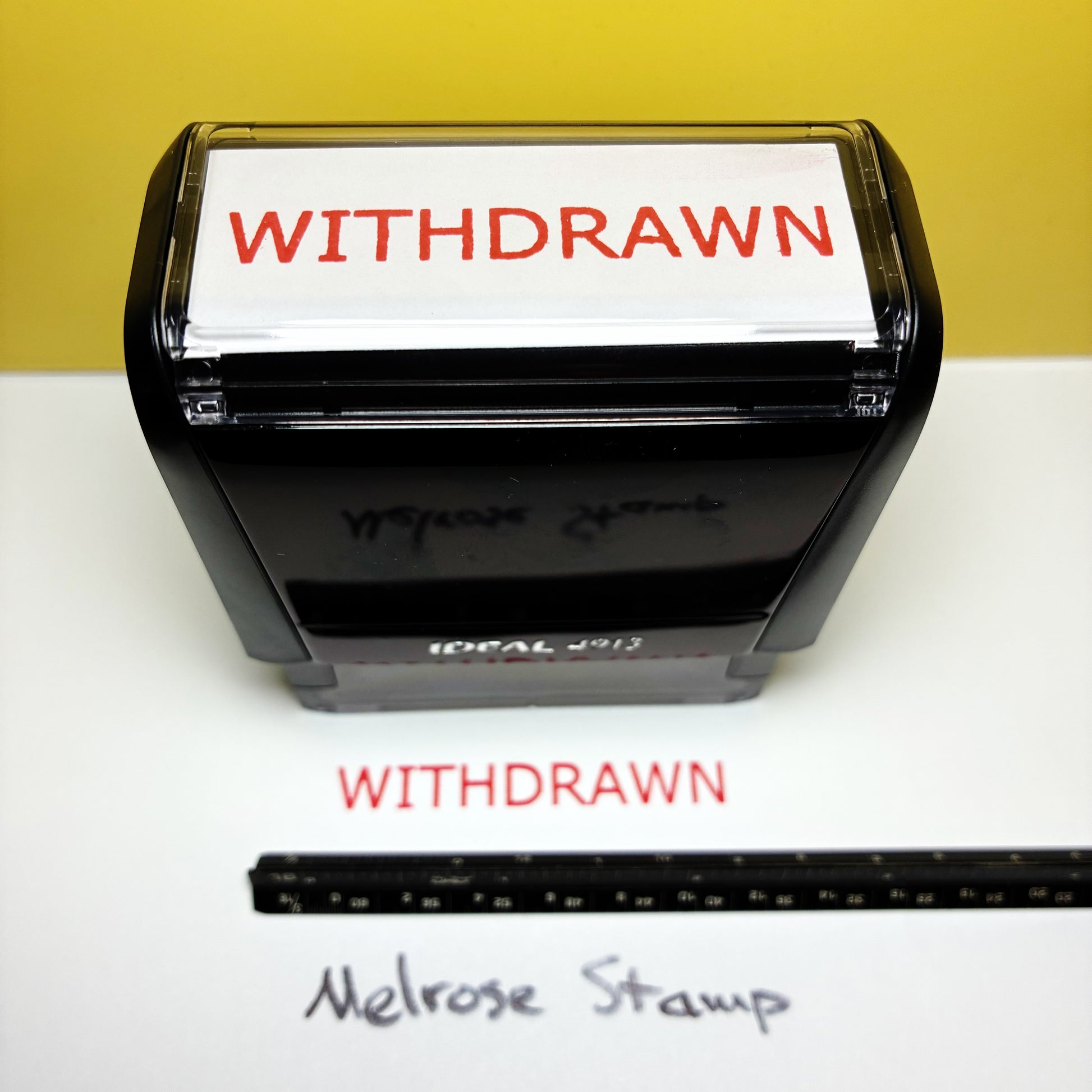 Rubber stamp with 'WITHDRAWN' text on a white background