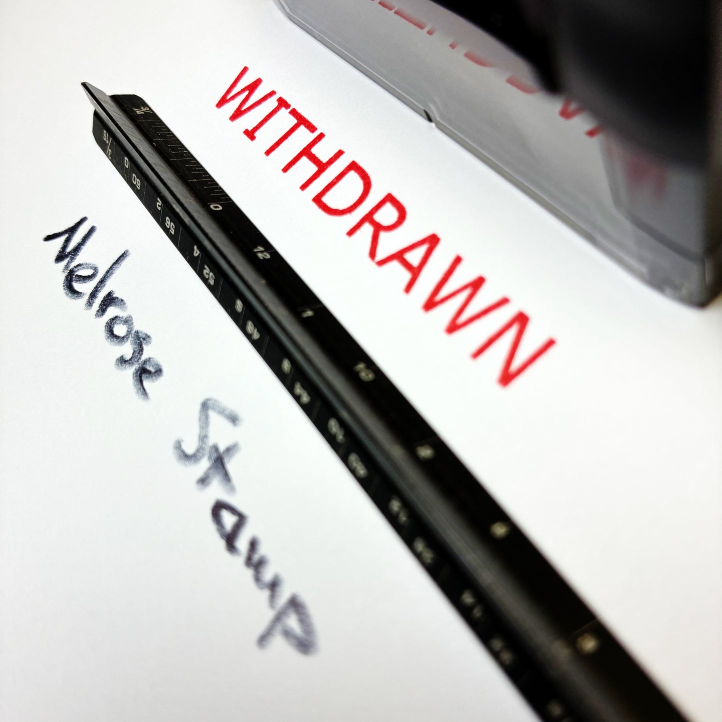 Rubber stamp with 'WITHDRAWN' and 'Melrose Stamp' text on a white background